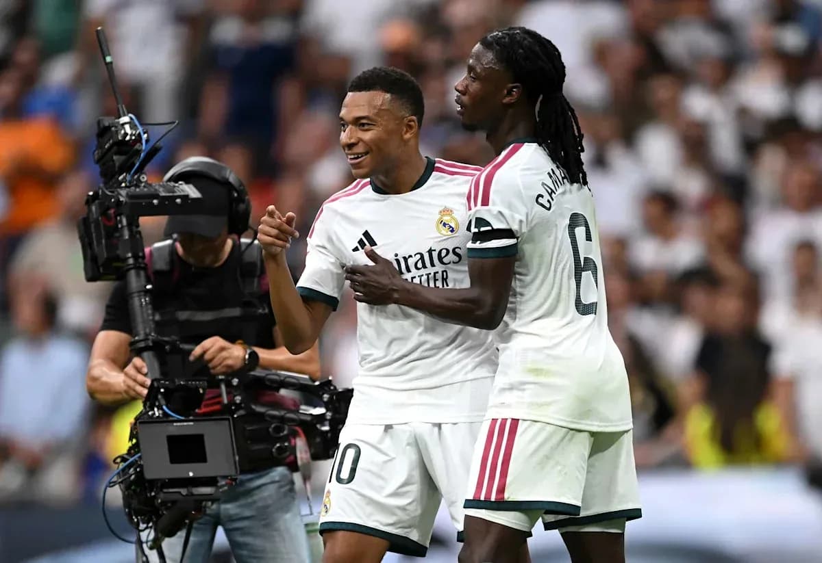 Two Real Madrid players celebrating on the field Two Real Madrid players celebrating on the field