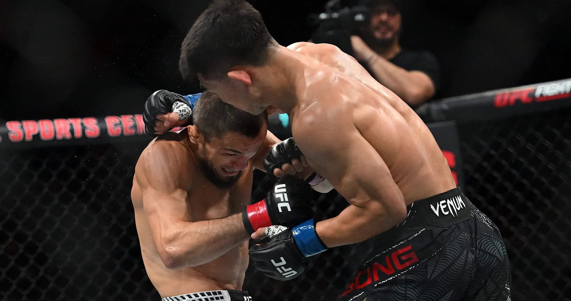 Two fighters exchanging punches in an MMA match Two fighters exchanging punches in an MMA match