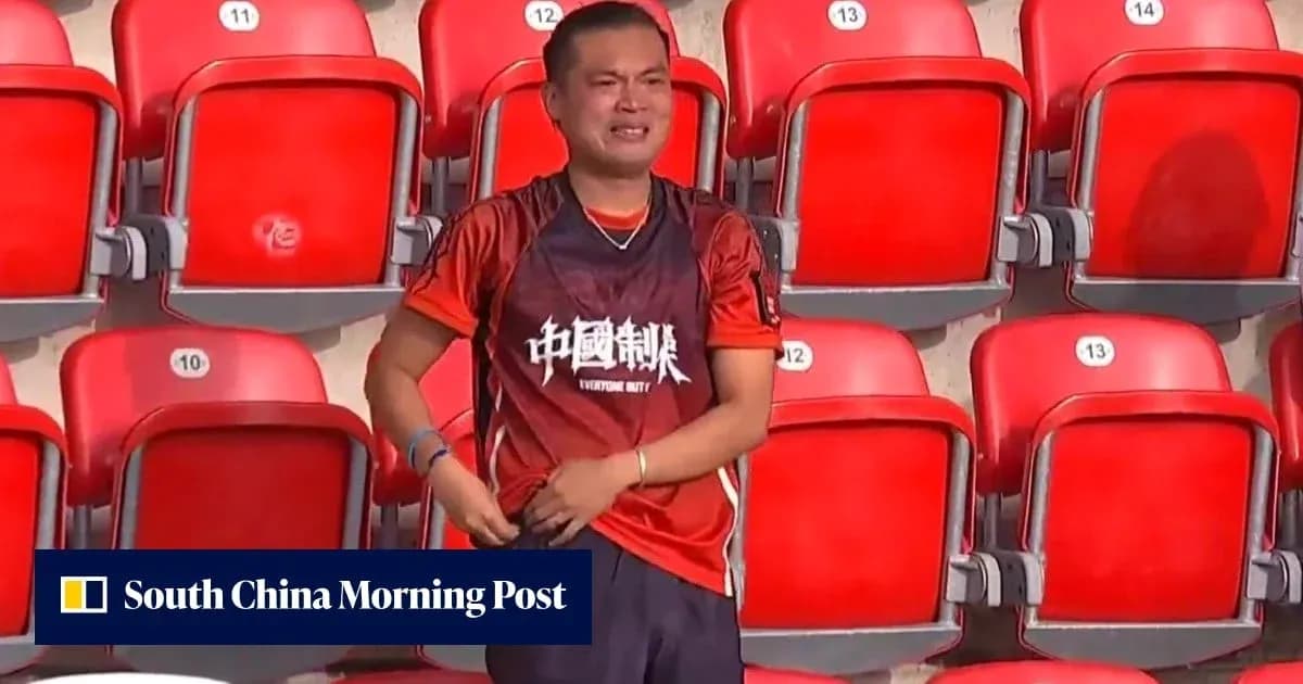 Fan in orange shirt standing in empty stadium seats Fan in orange shirt standing in empty stadium seats
