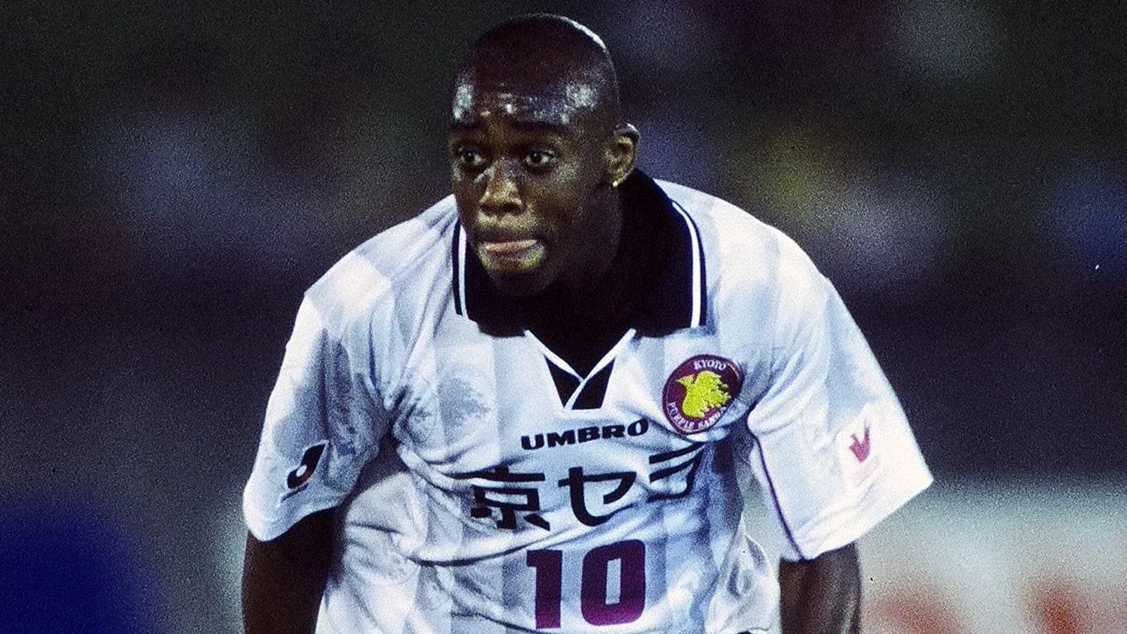 Player in action wearing a white football jersey Player in action wearing a white football jersey
