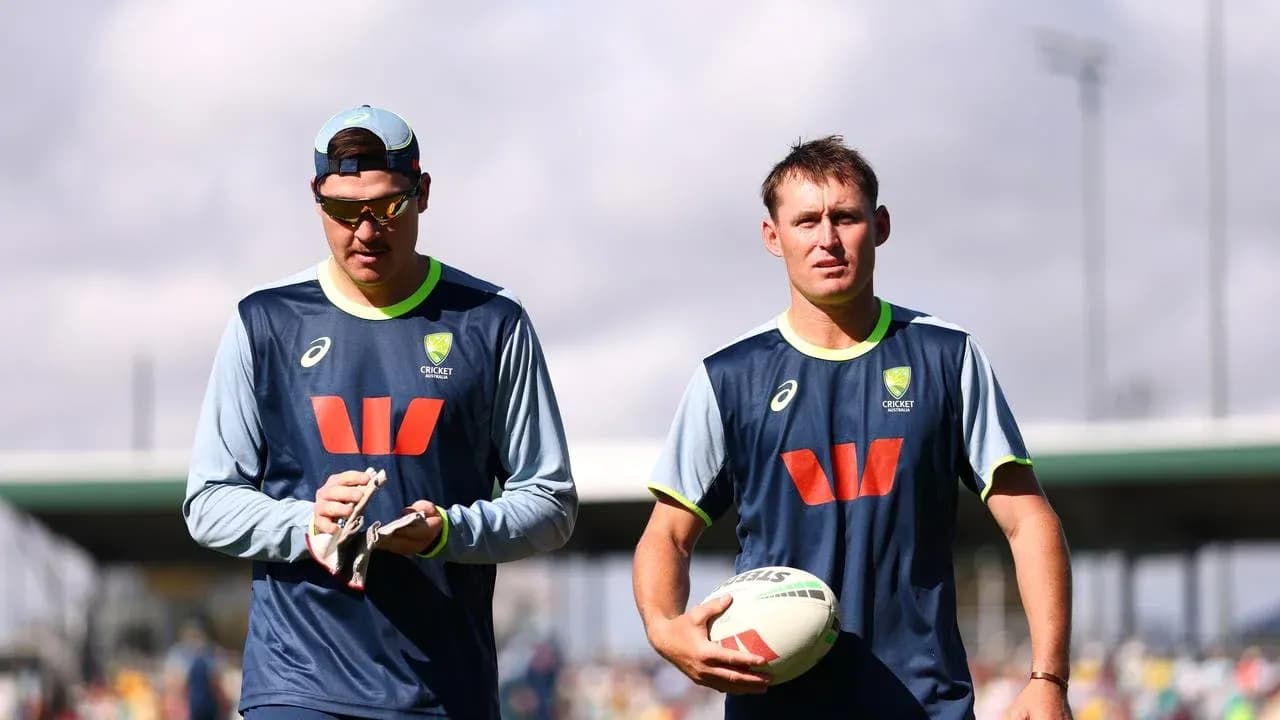 Two cricket players walking during training session Two cricket players walking during training session