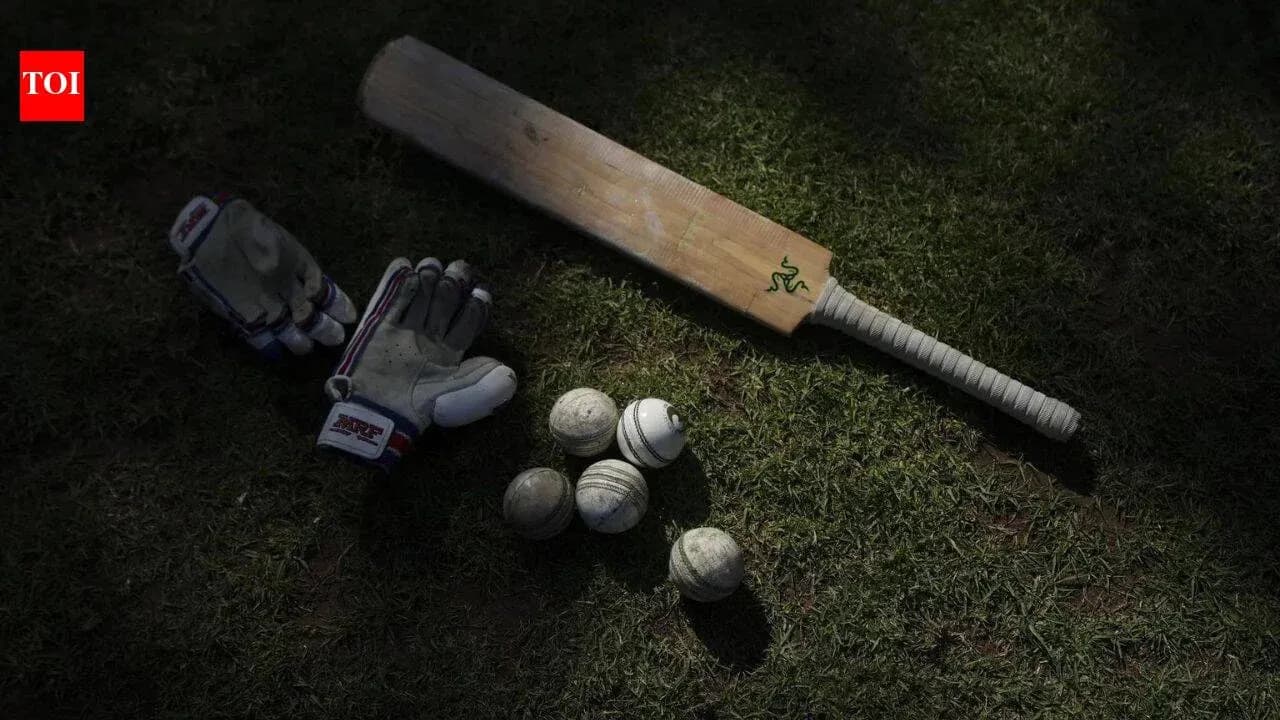 Cricket bat, gloves, and balls on grass Cricket bat, gloves, and balls on grass