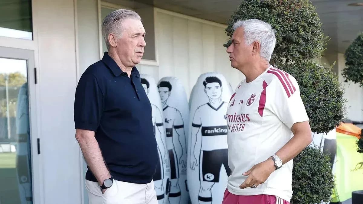 Two coaches talking at training ground with mannequins Two coaches talking at training ground with mannequins