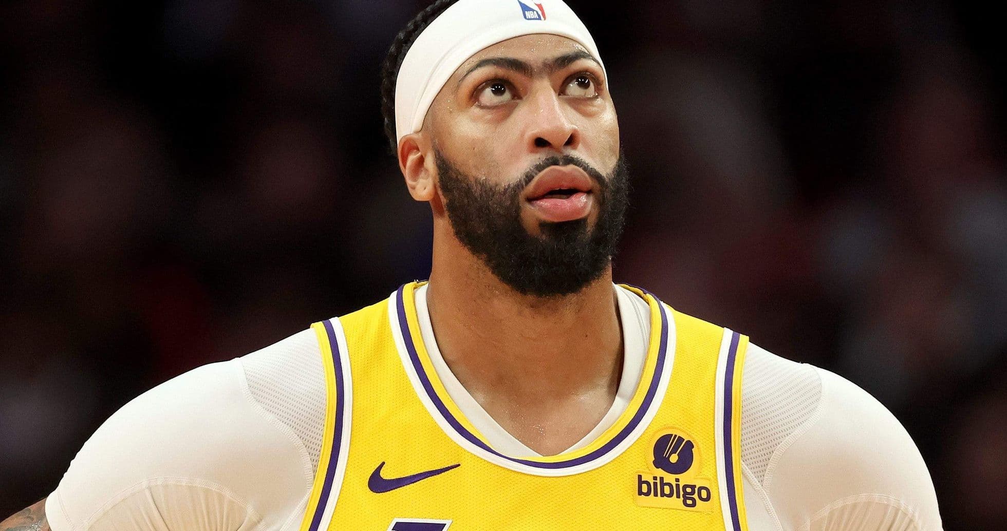 Player in Lakers jersey looking upwards during game Player in Lakers jersey looking upwards during game