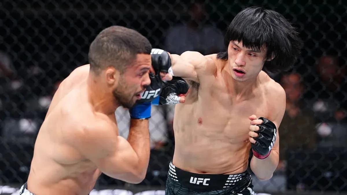 Fighter delivering a punch during UFC match Fighter delivering a punch during UFC match