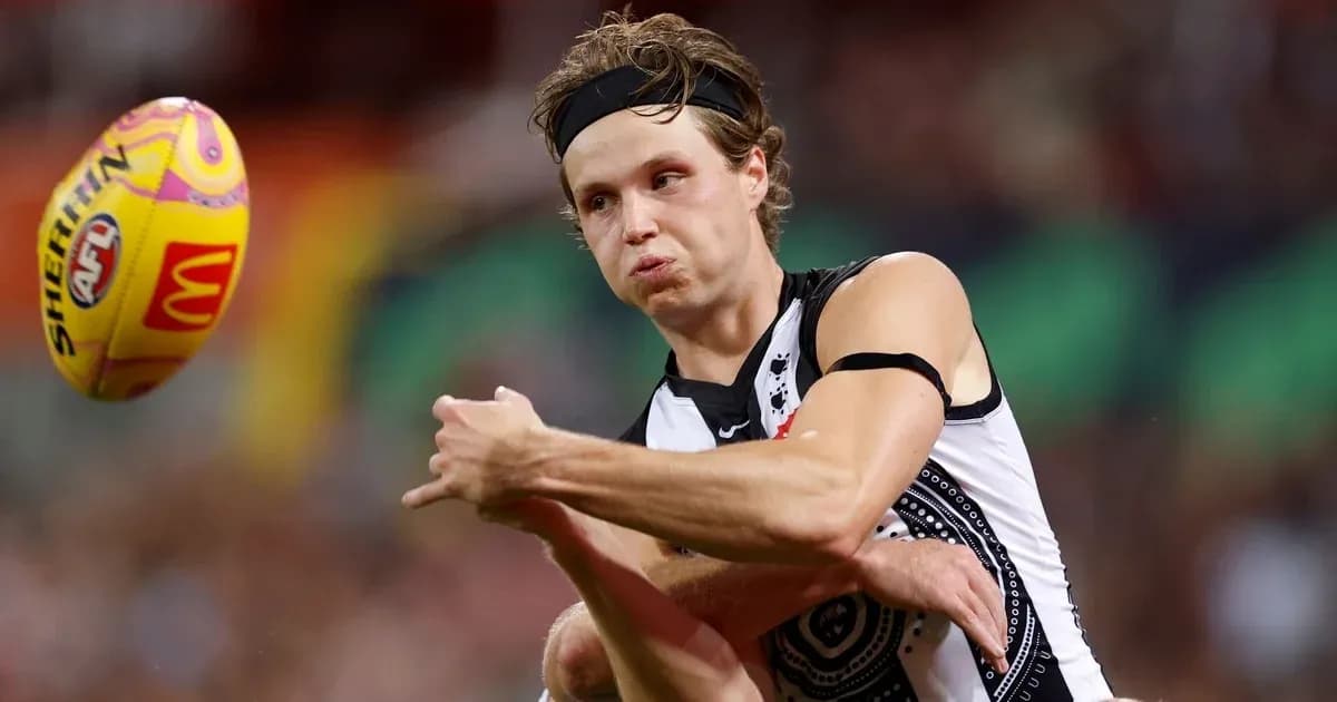 Player kicking an AFL football during match Player kicking an AFL football during match