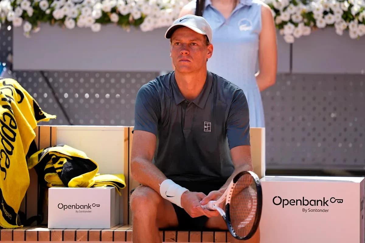Tennis player seated on bench during match break Tennis player seated on bench during match break