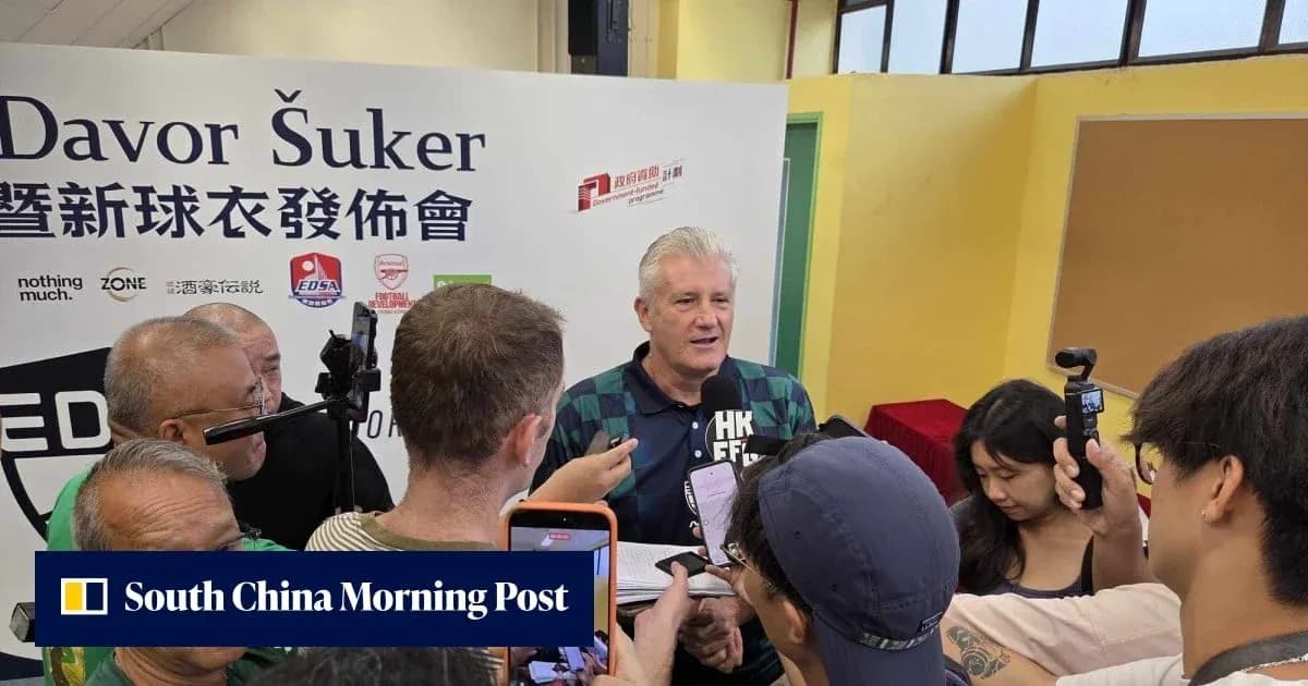 Davor Šuker speaking at a press event surrounded by reporters Davor Šuker speaking at a press event surrounded by reporters