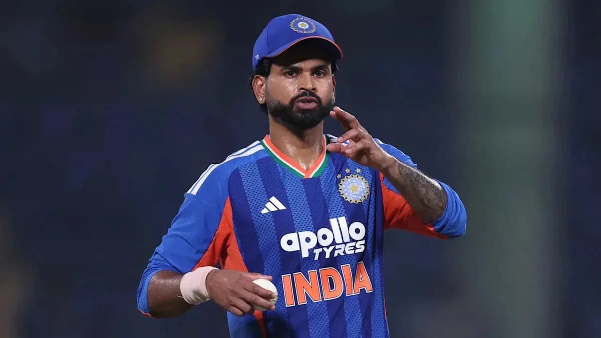 Cricketer gesturing while holding a cricket ball Cricketer gesturing while holding a cricket ball