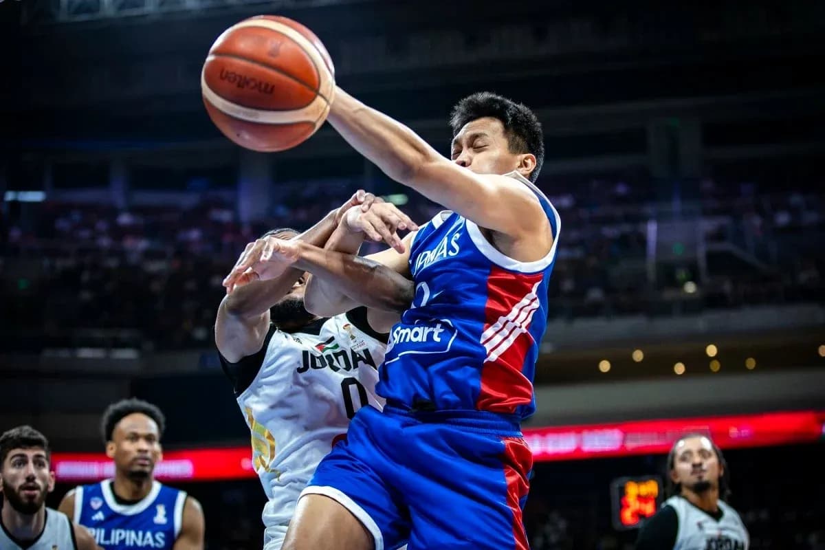 Player from Philippines contesting ball against Jordan opponent Player from Philippines contesting ball against Jordan opponent