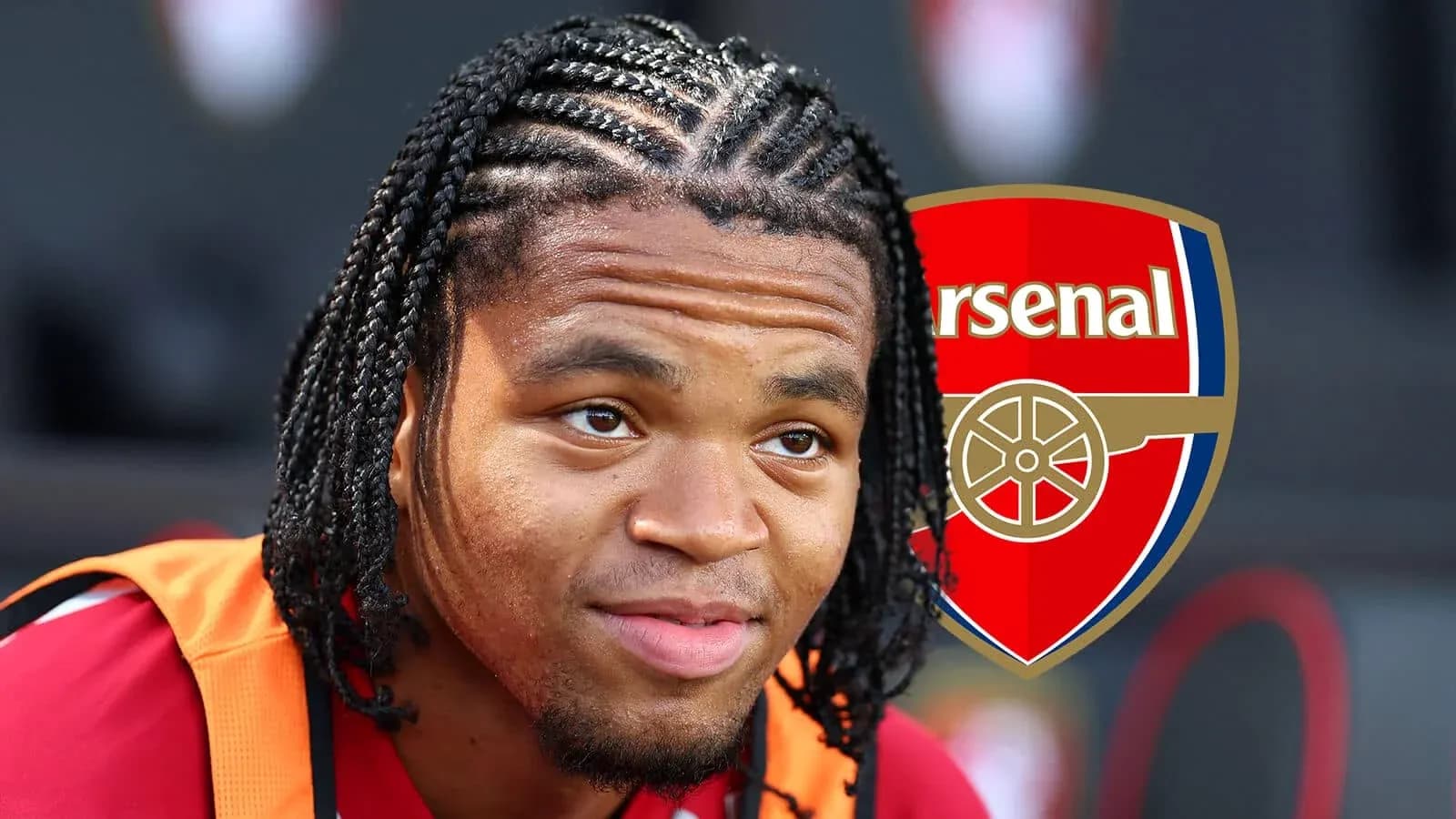 Player with braided hair sitting near Arsenal logo Player with braided hair sitting near Arsenal logo