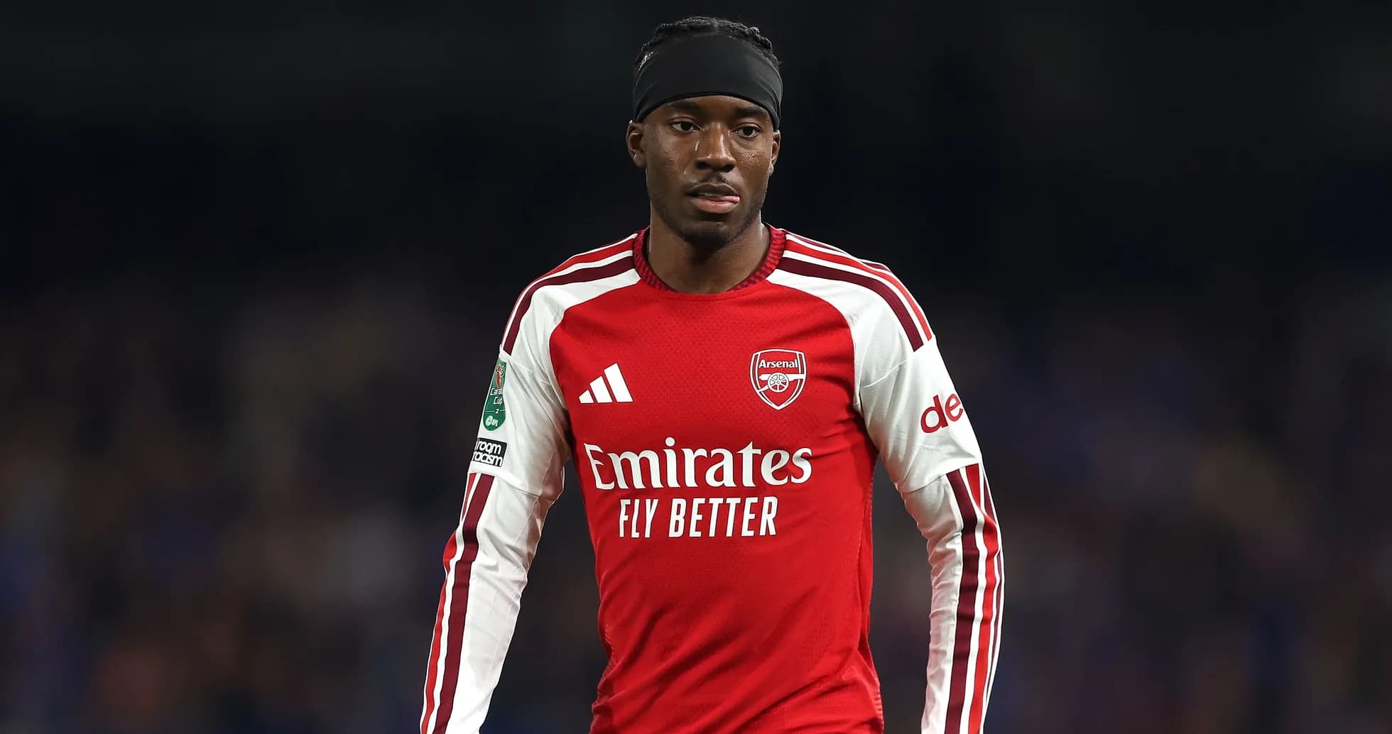 Arsenal player wearing red jersey on the field Arsenal player wearing red jersey on the field