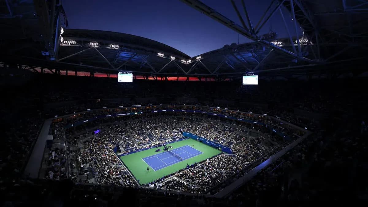 Crowd watching tennis match at night in stadium Crowd watching tennis match at night in stadium