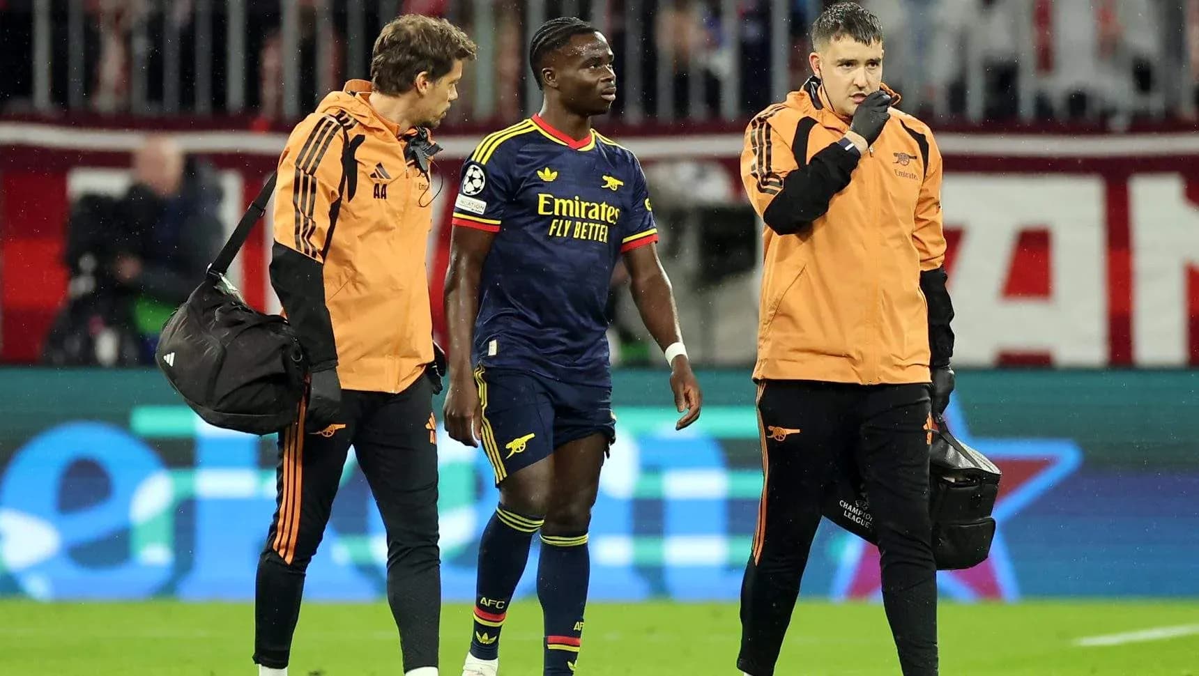 Player receiving medical attention from staff on field Player receiving medical attention from staff on field