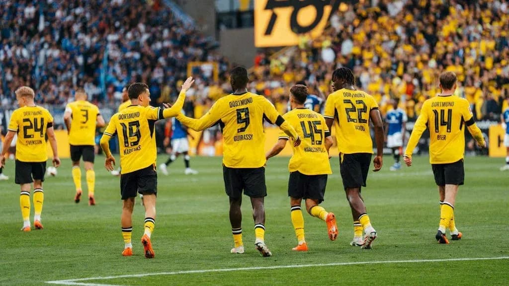 Borussia Dortmund players celebrating a goal together Borussia Dortmund players celebrating a goal together