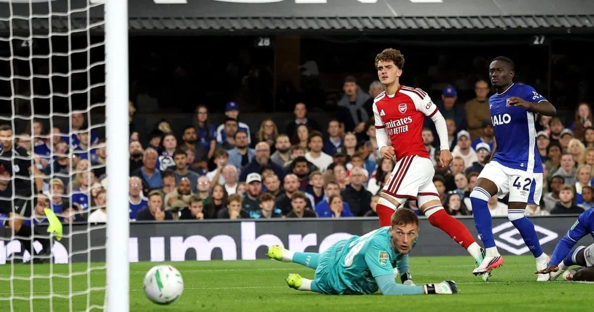 Arsenal player celebrating after scoring against opponent Arsenal player celebrating after scoring against opponent