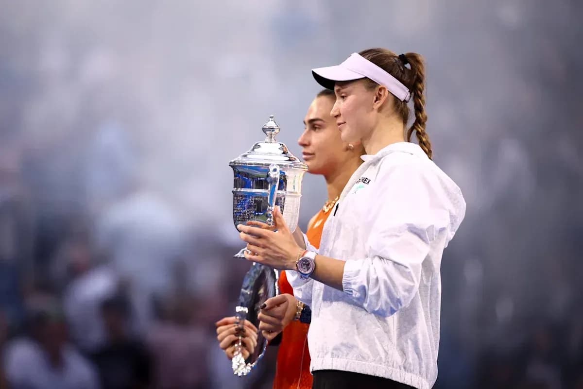 Two tennis players holding trophies after a match Two tennis players holding trophies after a match
