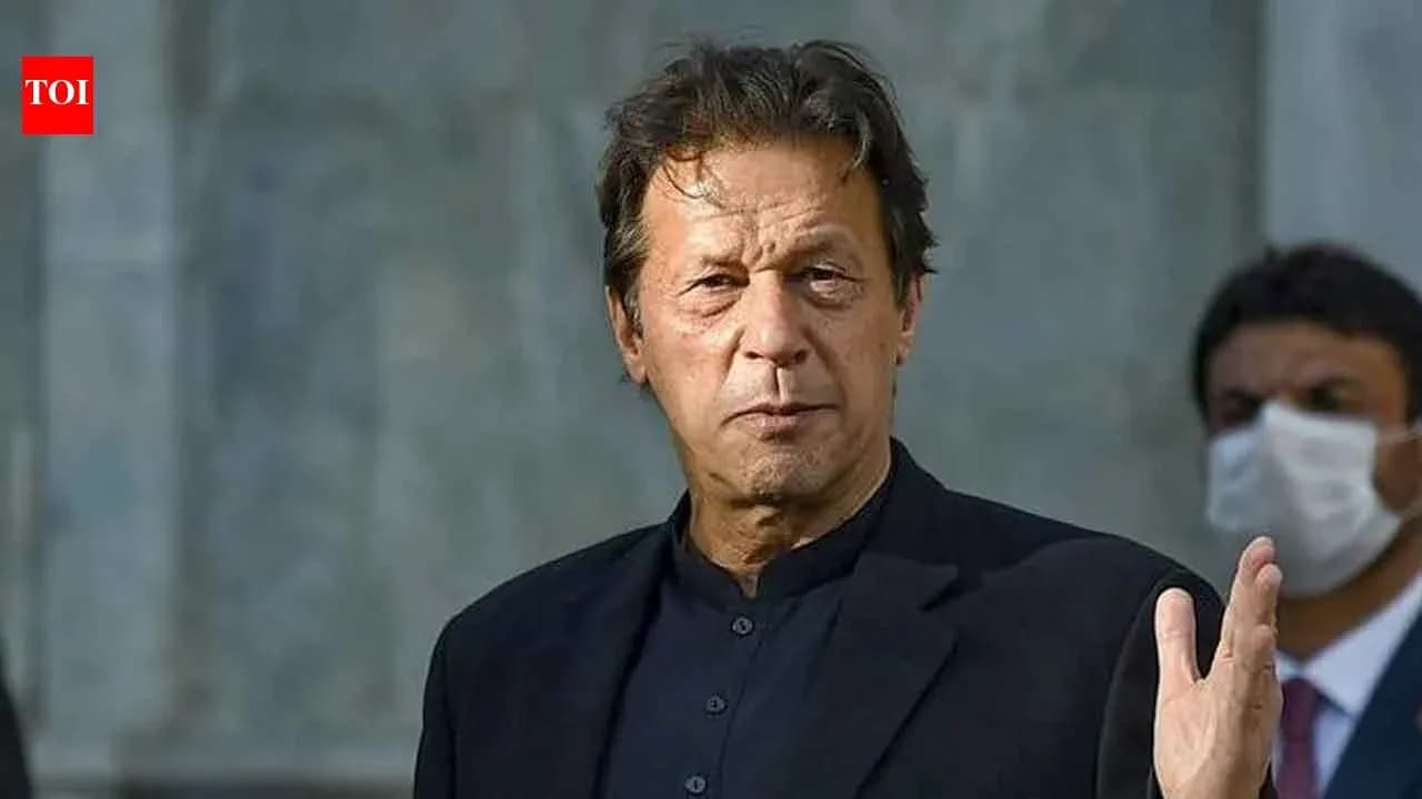 Man gesturing while speaking at a public event Man gesturing while speaking at a public event