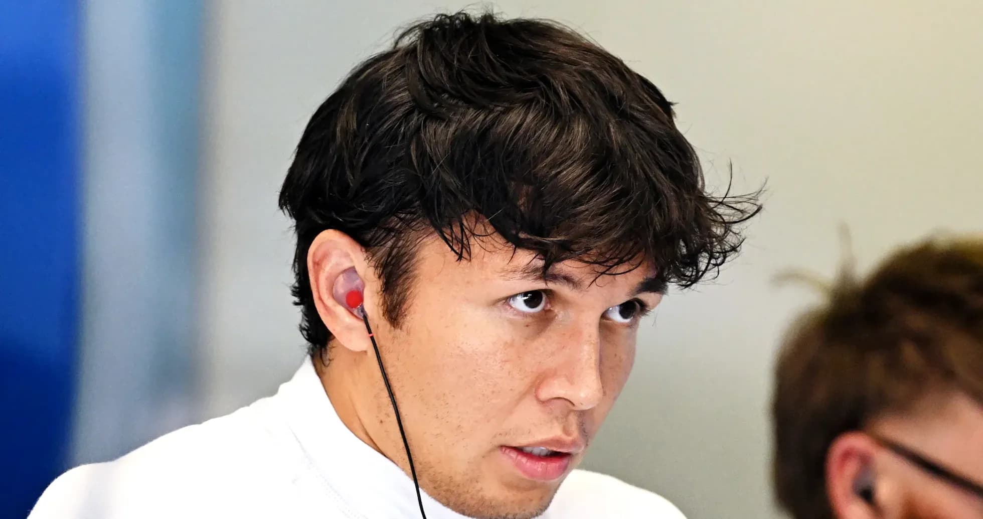 Driver wearing earphones in team setting Driver wearing earphones in team setting