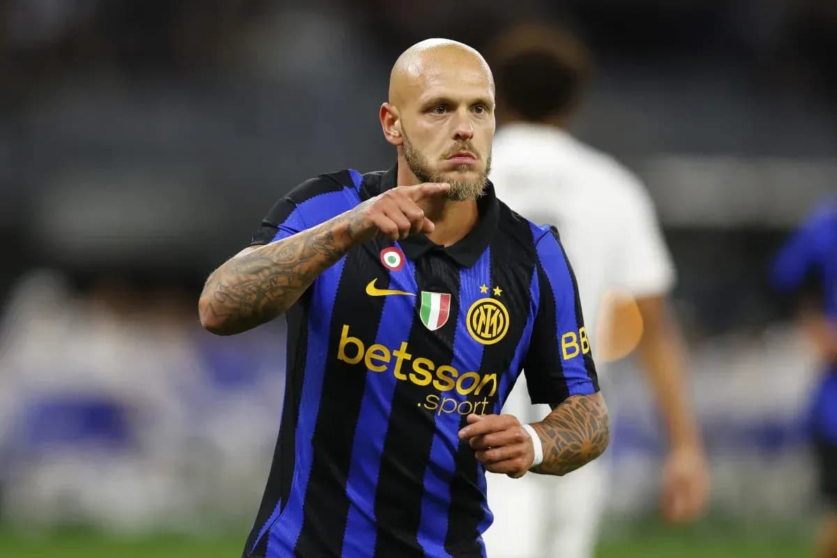 Player in black and blue jersey celebrating on field Player in black and blue jersey celebrating on field