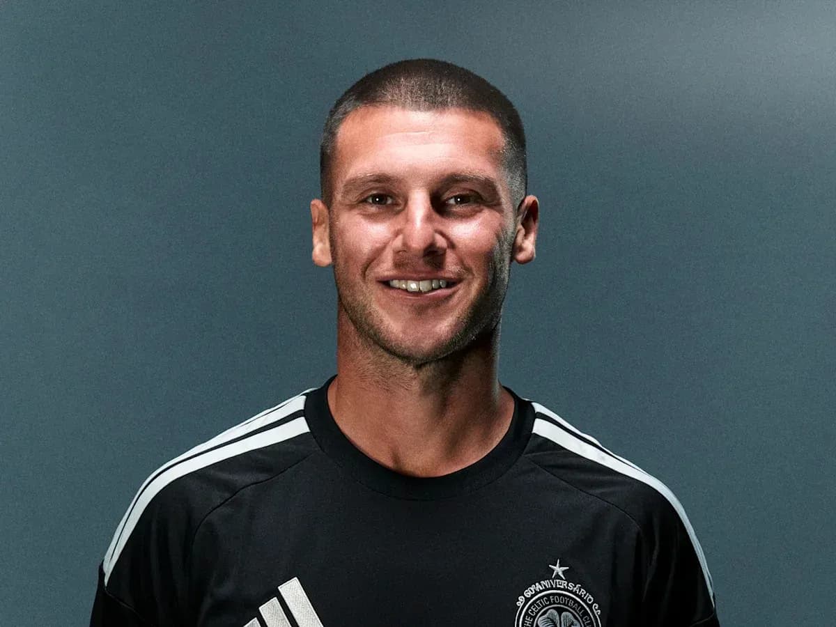 Player posing in black jersey with team logo Player posing in black jersey with team logo