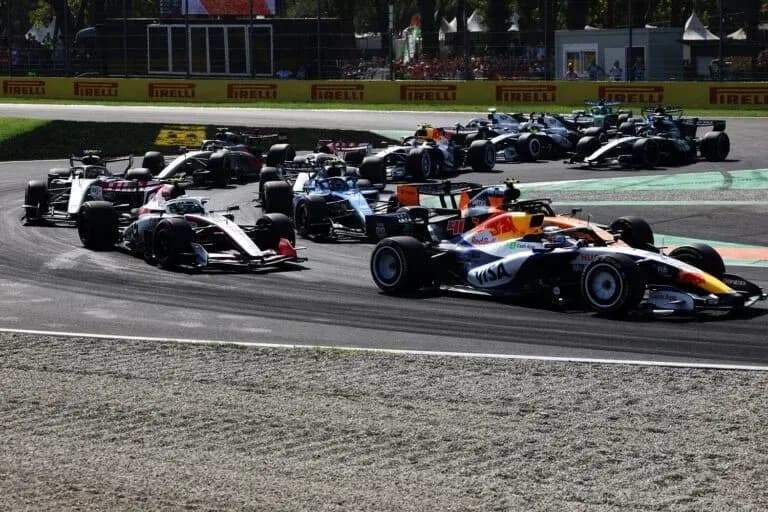 Formula 1 cars racing on track during competition Formula 1 cars racing on track during competition