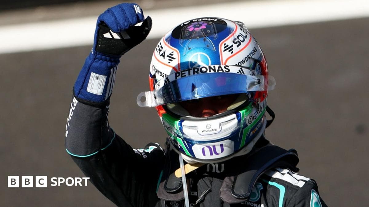 Racing driver celebrating victory with raised fist Racing driver celebrating victory with raised fist