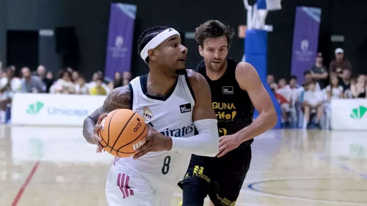 Player dribbling basketball during match against opponent Player dribbling basketball during match against opponent