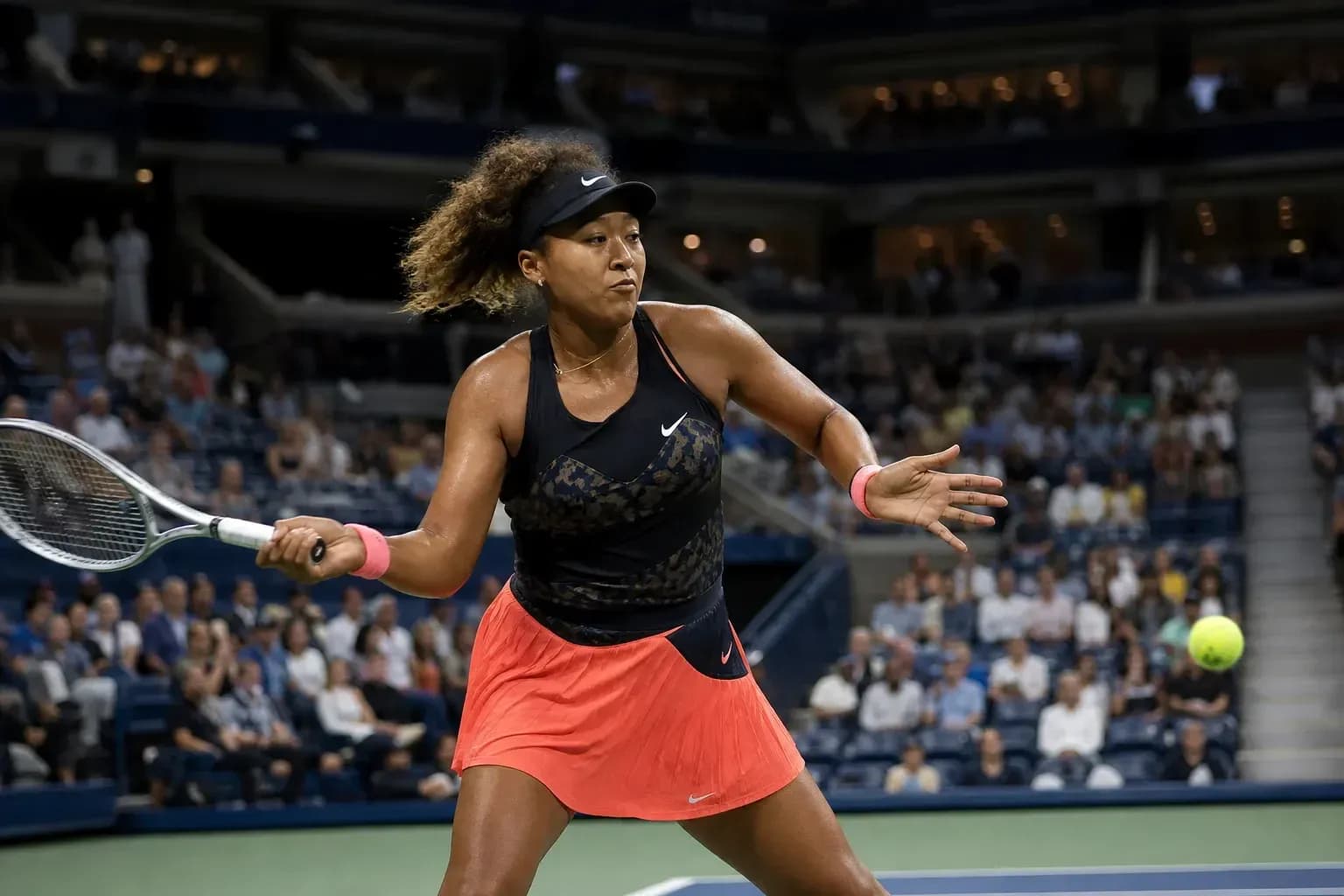 Naomi Osaka preparing to hit a tennis ball Naomi Osaka preparing to hit a tennis ball