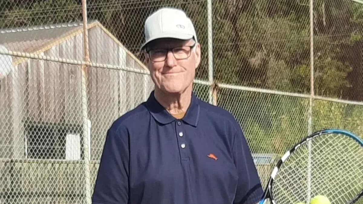 Older man holding a tennis racket on court Older man holding a tennis racket on court
