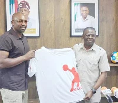 Two men holding a T-shirt in an office Two men holding a T-shirt in an office