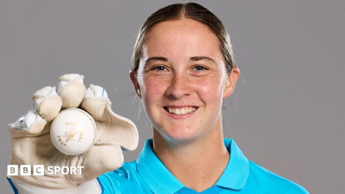 Cricketer holding a ball and smiling at camera Cricketer holding a ball and smiling at camera