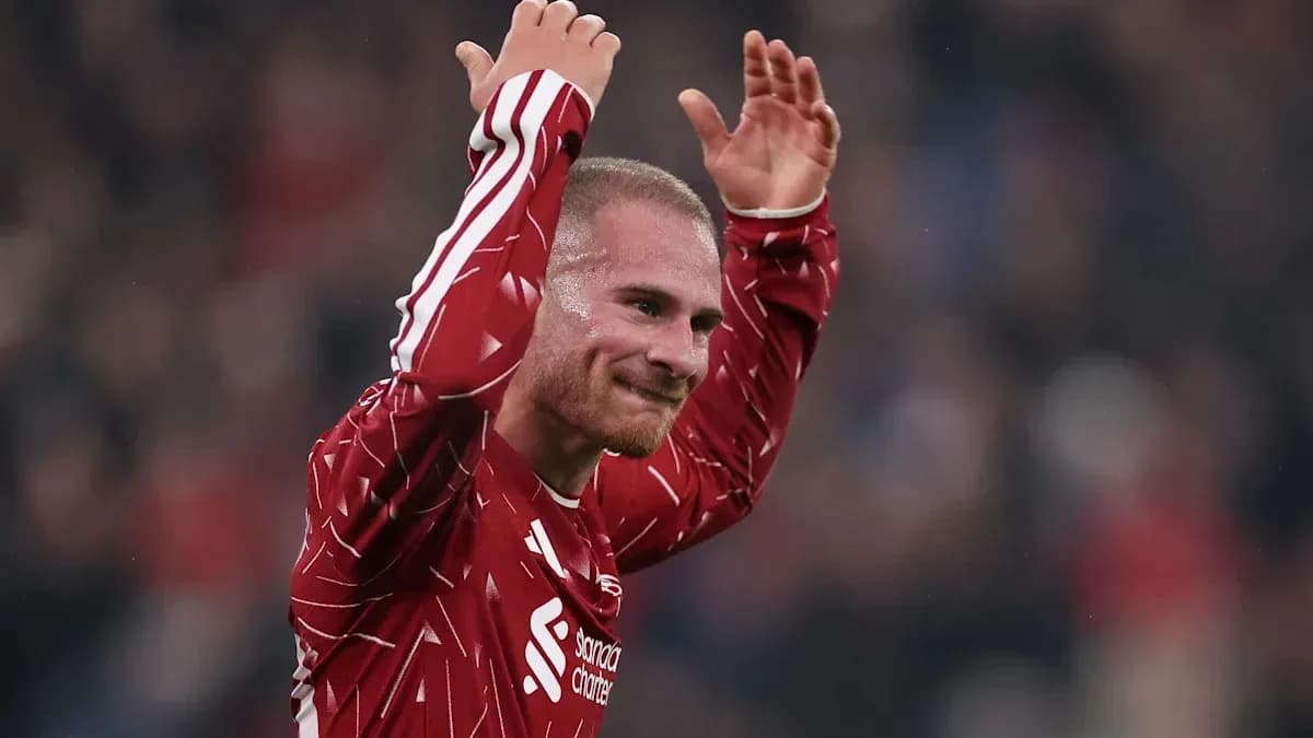 Player celebrating with raised arms on the field Player celebrating with raised arms on the field