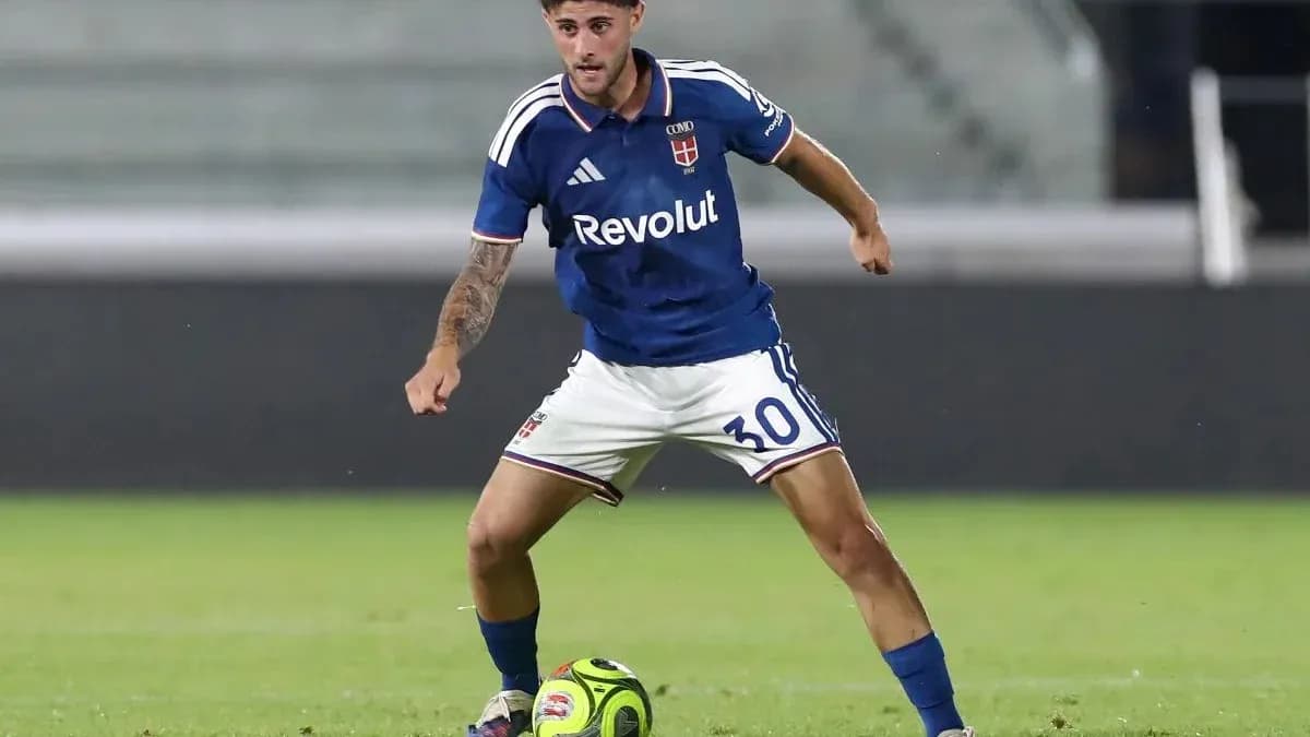 Player in blue kit dribbling soccer ball on field Player in blue kit dribbling soccer ball on field