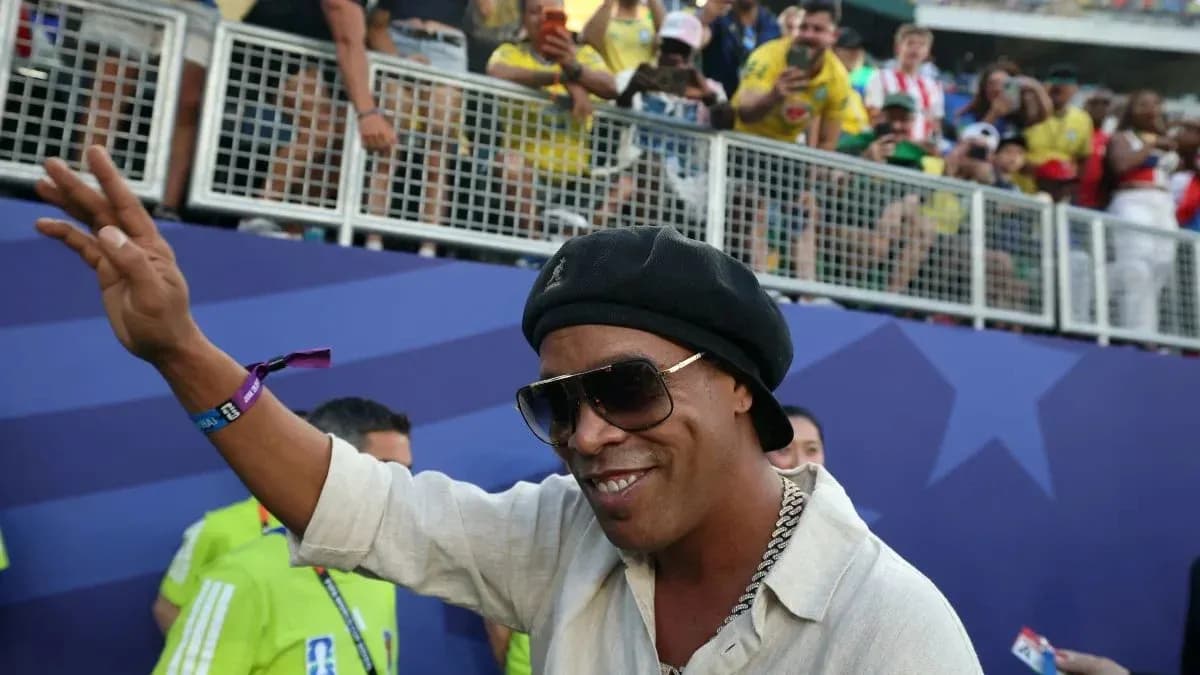Person waving at fans in stadium stands Person waving at fans in stadium stands