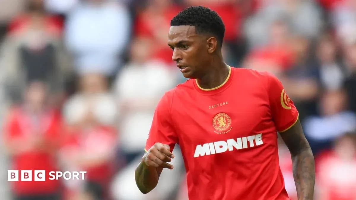 Player in red kit running on the field Player in red kit running on the field