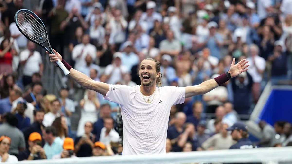 Player celebrating victory with arms raised in crowd Player celebrating victory with arms raised in crowd