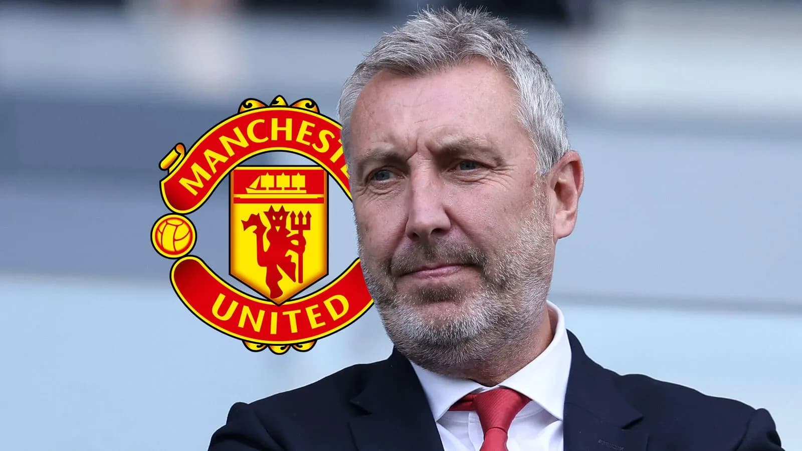 Man in suit with Manchester United logo background Man in suit with Manchester United logo background