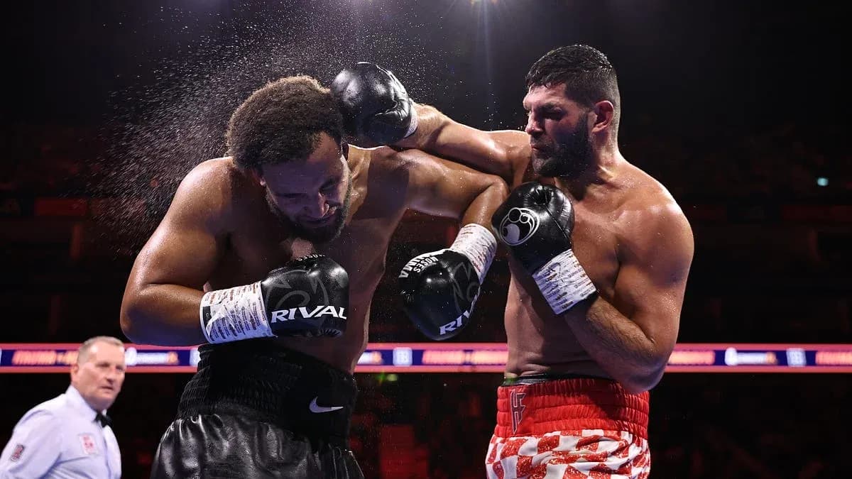 Boxers exchanging punches in a boxing match Boxers exchanging punches in a boxing match