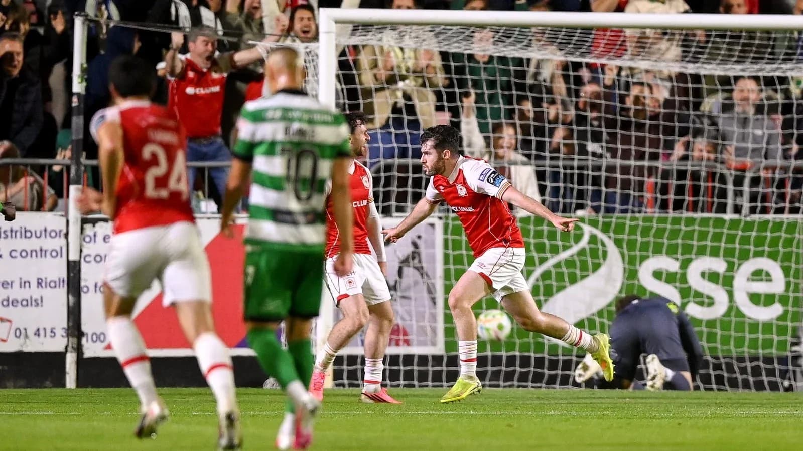Player celebrating a goal with teammates during match Player celebrating a goal with teammates during match