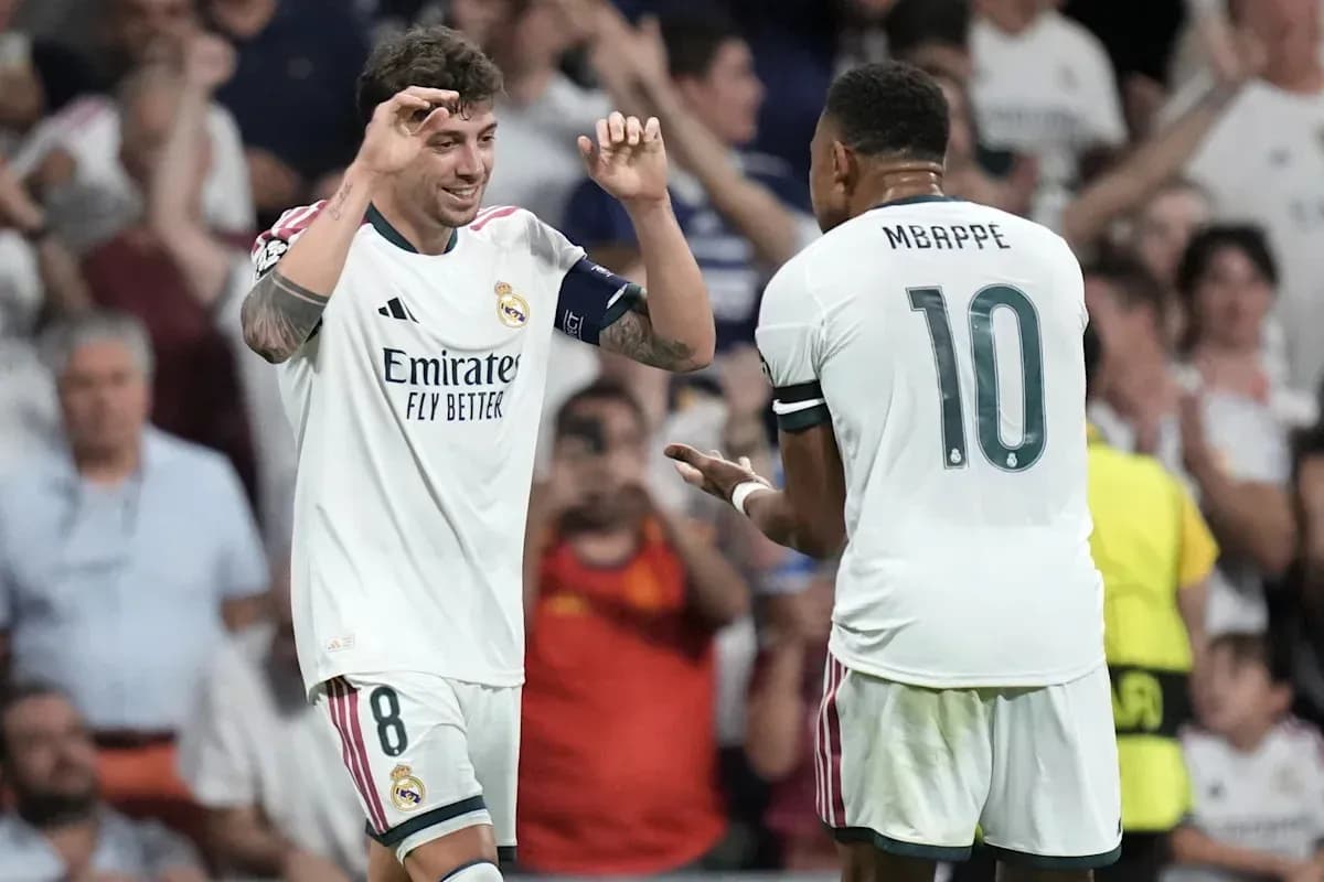 Two Real Madrid players celebrating a goal together Two Real Madrid players celebrating a goal together