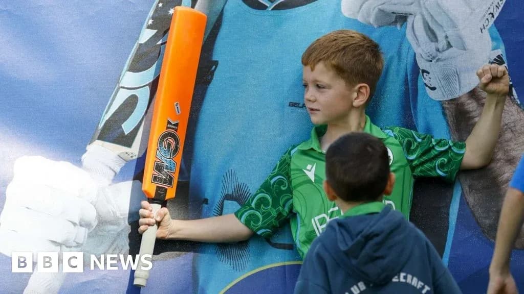 Child posing with cricket bat and poster backdrop Child posing with cricket bat and poster backdrop