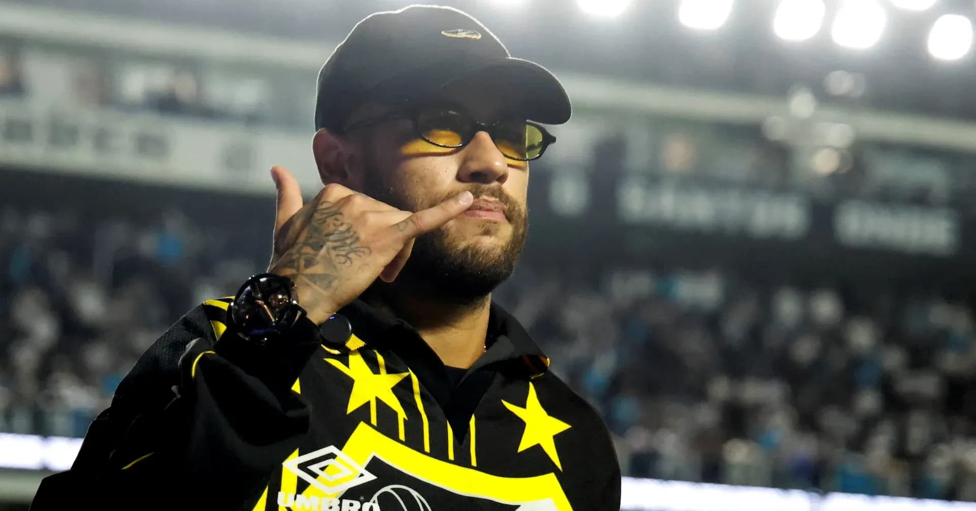Person making a gesture in a sports venue Person making a gesture in a sports venue