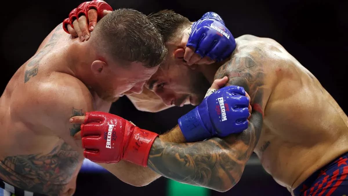 Two fighters clinching during a match in the ring Two fighters clinching during a match in the ring
