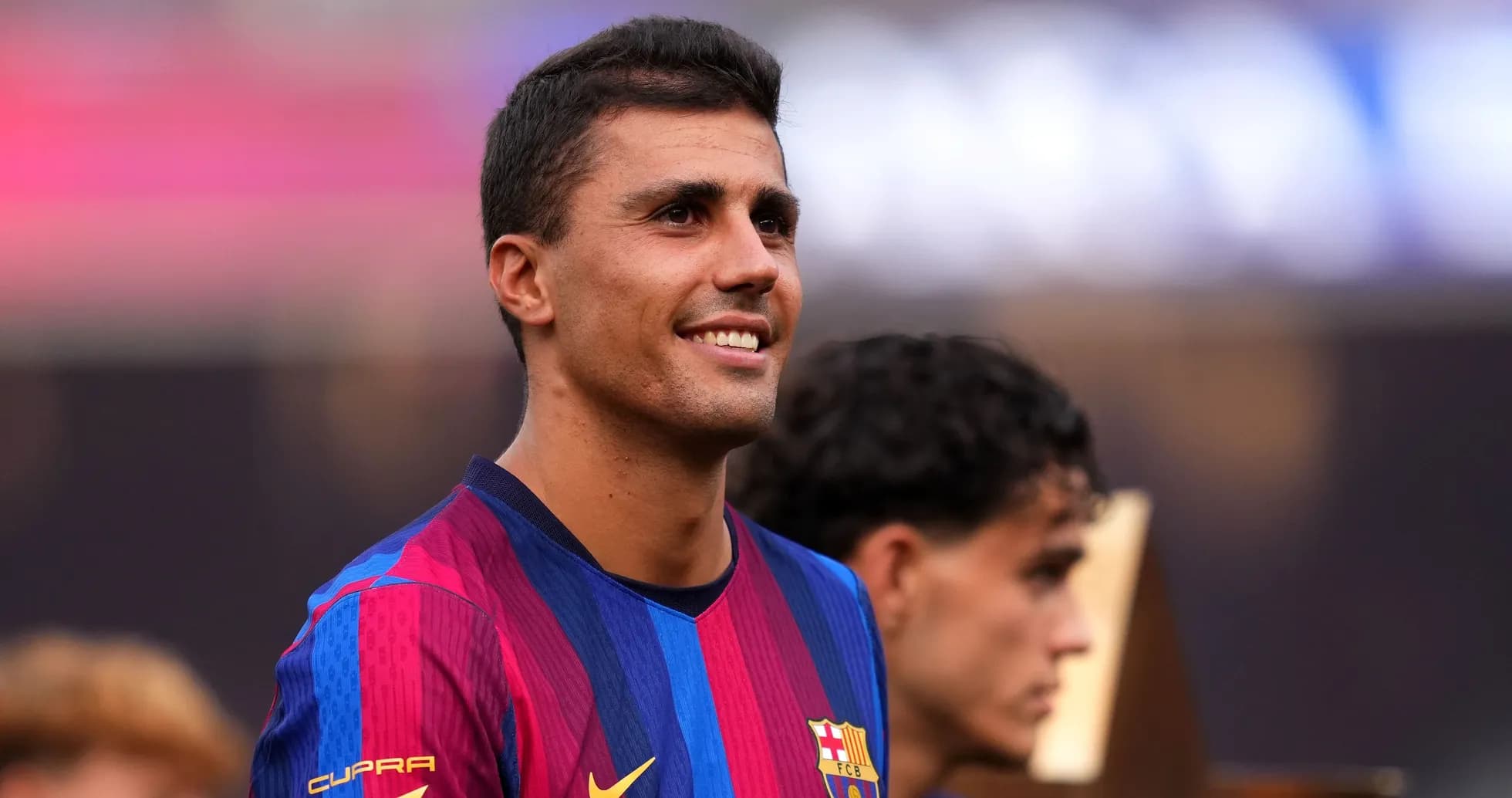 Player smiling during post-match celebration with teammates Player smiling during post-match celebration with teammates