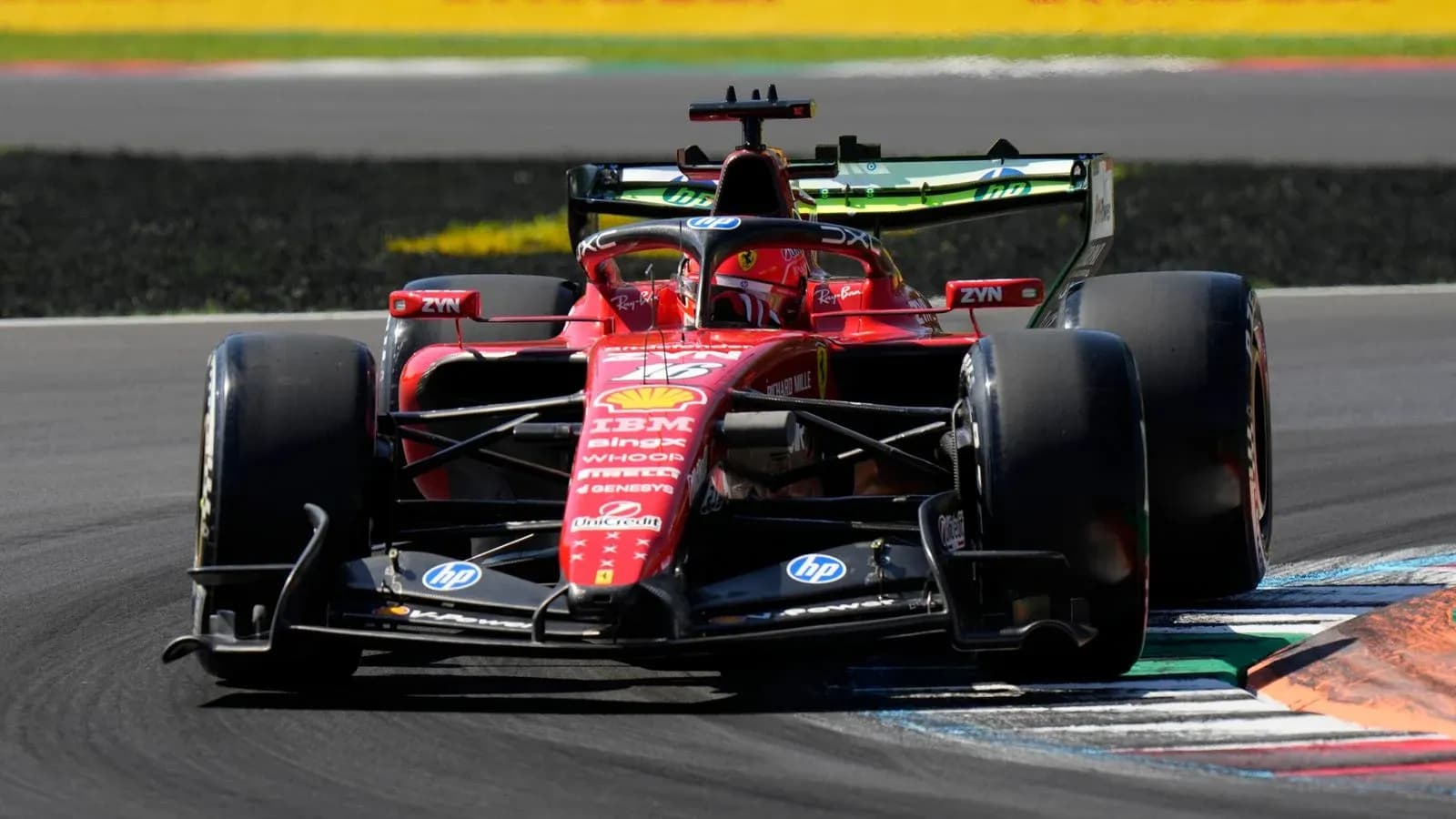 Ferrari car navigating a corner on racetrack Ferrari car navigating a corner on racetrack