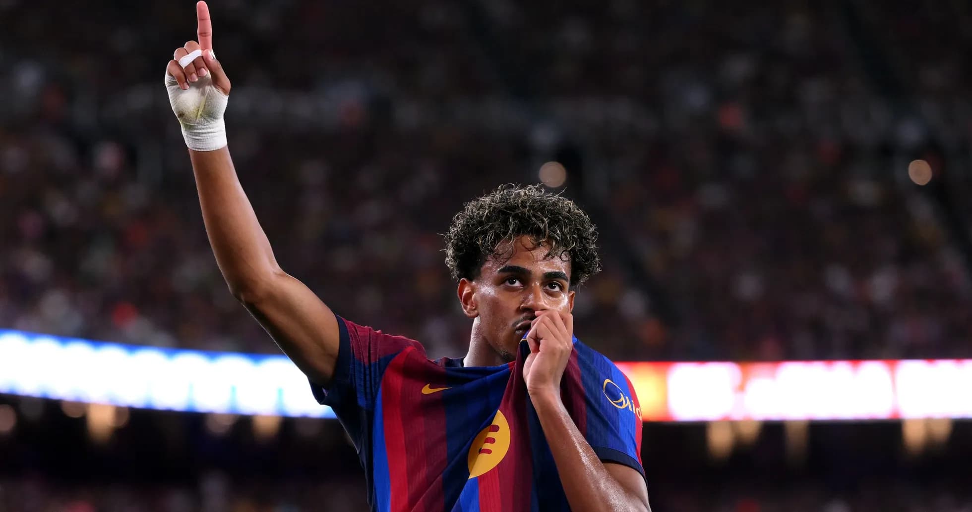 Player celebrating and holding shirt after scoring Player celebrating and holding shirt after scoring