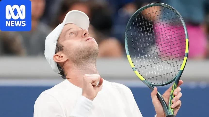 Tennis player celebrating with racket raised in victory Tennis player celebrating with racket raised in victory