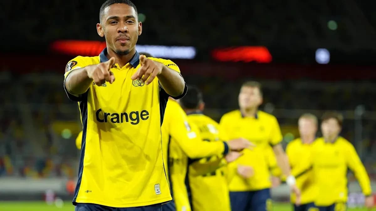 Player celebrating in yellow jersey with teammates Player celebrating in yellow jersey with teammates