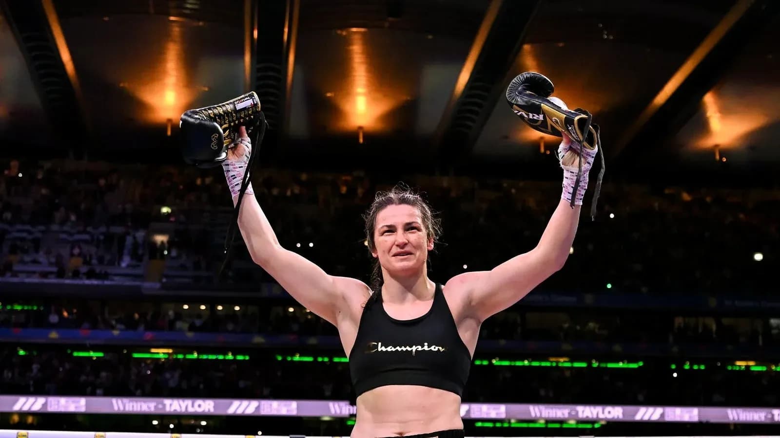 Athlete celebrating victory with boxing gloves raised Athlete celebrating victory with boxing gloves raised